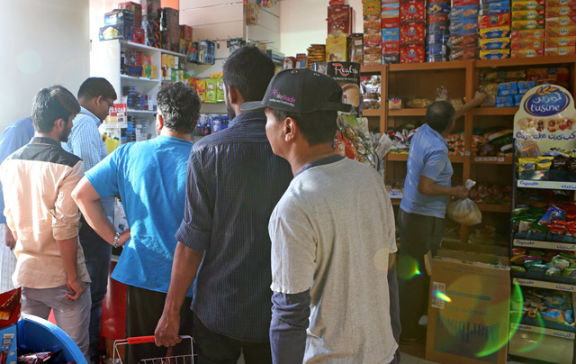 People buy snacks at a shop in Doha on Monday (AFP photo)
