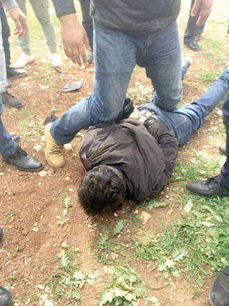 A photo posted on social media platforms purportedly shows citizens arrest a bank robber after he fled the scene in Amman on Thursday (Facebook photo)