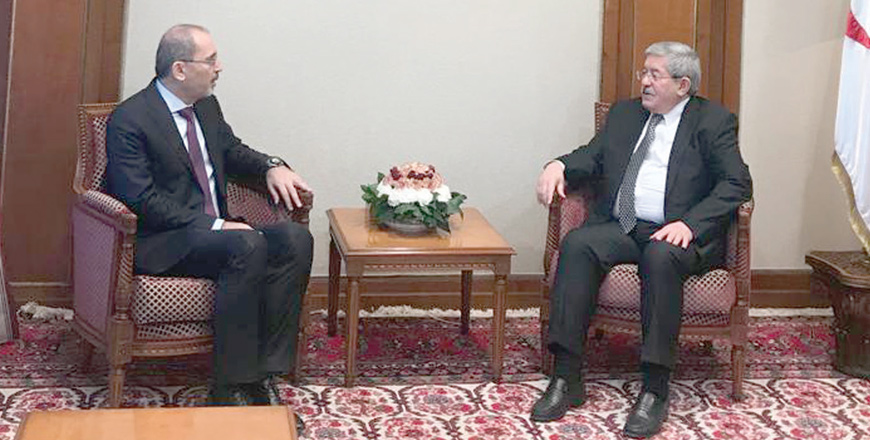 Minister of Foreign Affairs and Expatriates Ayman Safadi meets with Algerian Prime Minister Ahmed Ouyahia in Algeria on Sunday (Photo courtesy of Foreign Ministry)