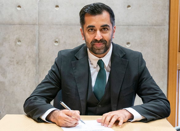 Newly elected leader of the Scottish National Party (SNP), Humza Yousaf signs the nomination form to become First Minister for Scotland at the Scottish Parliament in Edinburgh, on Tuesday (AFP photo)