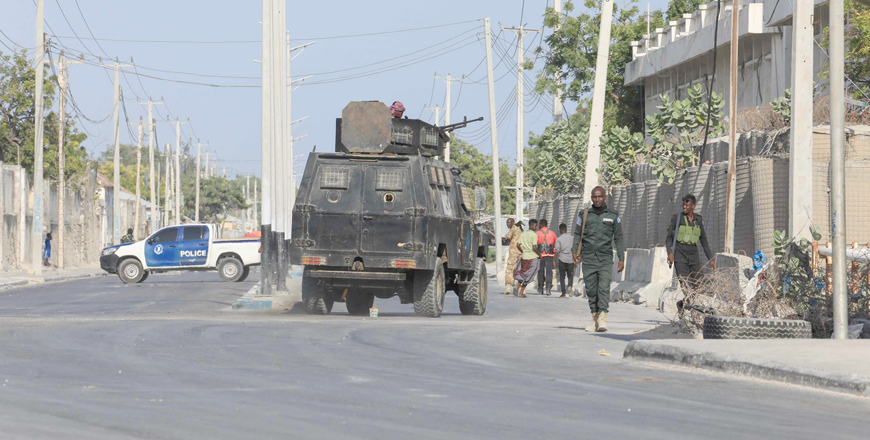 Security forces patrol outside a building which was attacked by suspected Al Shabaab militants in the Somalia capital Mogadishu, on February 21(AFP photo)