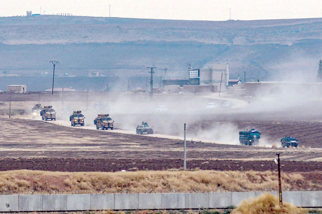 Turkish and Russian military vehicles return from a joint patrol in the countryside of Kiziltepe town in Syria's northeastern Mardin province on the Syrian-Turkish border on Friday (AFP photo)