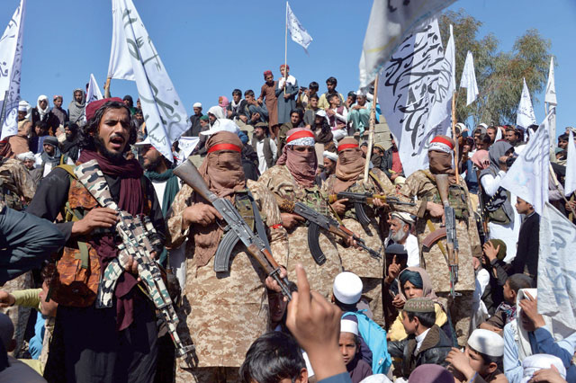 Afghan Taliban militants and villagers attend a gathering as they celebrate the peace deal in Alingar district of Laghman Province, on Monday (AFP photo)