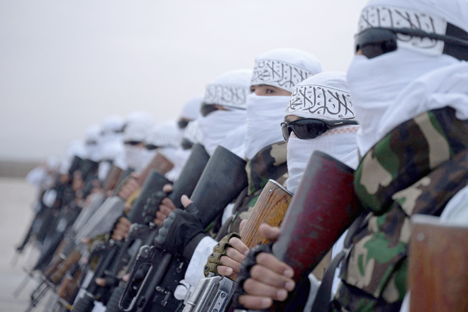 In this photograph taken on Saturday, Taliban fighters stand guard during a military street parade in Maymana, capital of Faryab province (AFP photo)