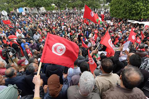 Tunisian demonstrators chant slogans and wave their country's national flag in support of President Kais Saied, in the capital Tunis, on Sunday (AFP photo)