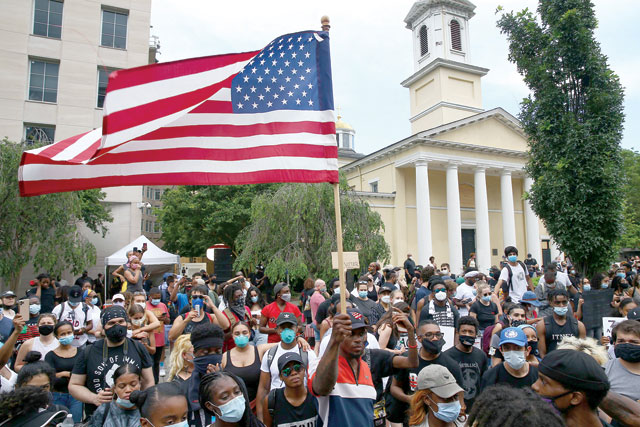 Demonstrators gather on 16th Street across from St Johns Episcopal Church while protesting against police brutality and the death of George Floyd, on Friday, in Washington, DC (AFP photo)