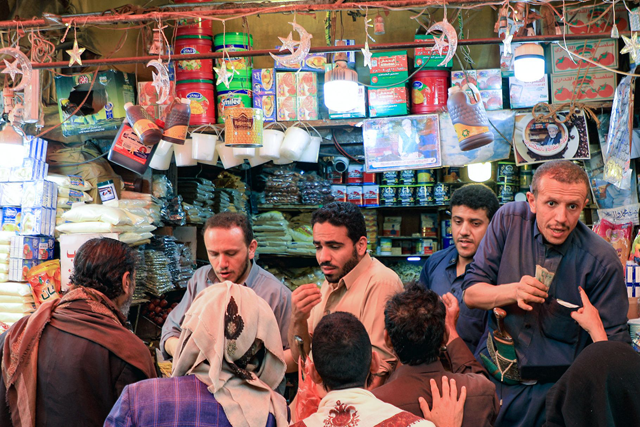 People buy food items at a market in Sanaa on March 18, 2023, ahead of the Muslim holy month of Ramadan (AFP photo)
