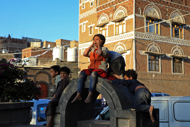 Children play in front of an UNESCO-listed building in the old city of the Yemeni capital Sanaa, on Sunday (AFP photo)
