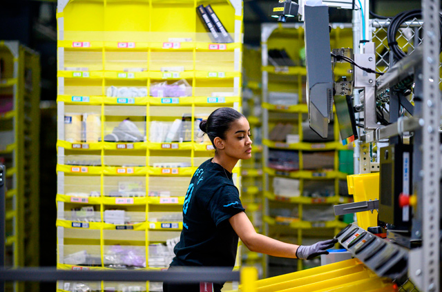 A woman works at a distribution station at the 79,432 square-metre Amazon fulfillment centre in Staten Island, one of the five boroughs of New York City, on February 5, 2019  (AFP file photo)