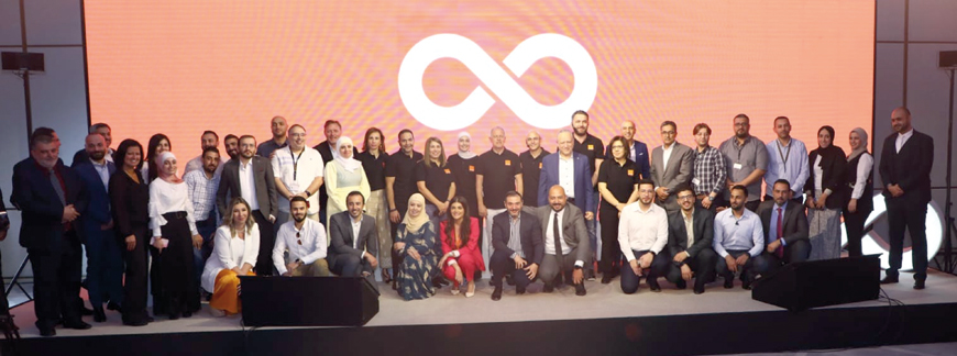 Orange Jordan team members pose for a group photo during the launch of the ‘Jood Orange’ application on Wednesday (Photo courtesy of Orange Jordan)