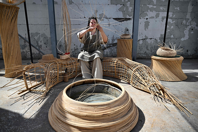A Lebanese artisan demonstrates her skills in making objects from rattan, during the annual event 'We Design Beirut', a large-scale exhibition that celebrates Lebanese innovation in the field of design, blending national heritage and modernity, in Beirut on May 23 (AFP photo)