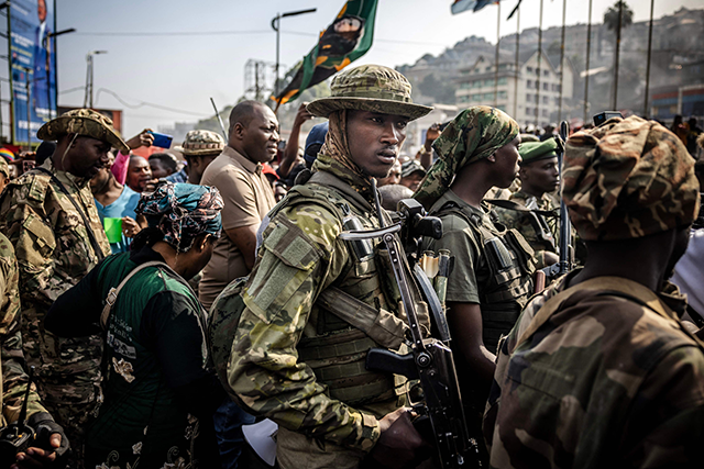 Members of the M23 movement monitor the area while guarding senior members of the group during a special cleaning exercise and public meeting conducted by the M23 movement following the takeover of the city at the Place de l'Independance in Bukavu today (AFP photo)