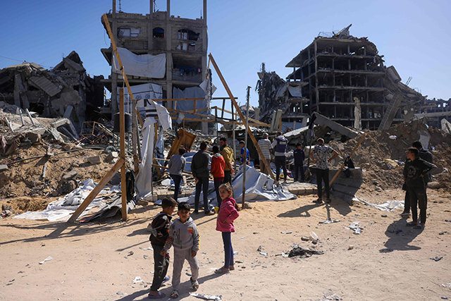 Children gather near a destroyed makeshift shelter following an Israeli strike in Beit Lahia on Thursday (AFP photo)
