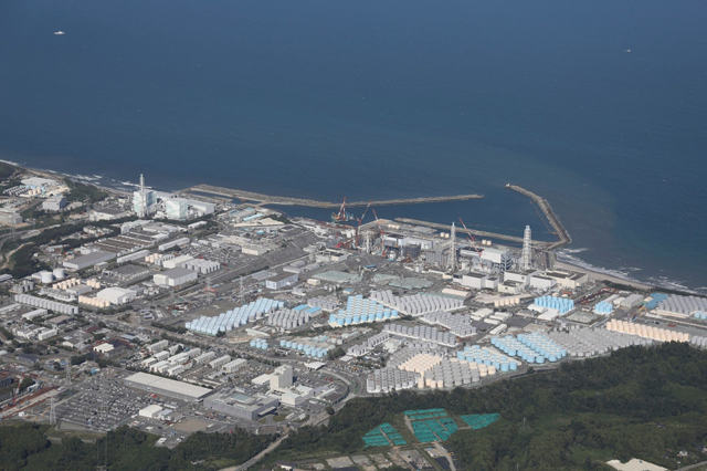 This aerial picture shows storage tanks (bottom) used for storing treated water at TEPCO's crippled Fukushima Daiichi Nuclear Power Plant in Okuma, Fukushima prefecture on August 24, 2023 (AFP Photo)