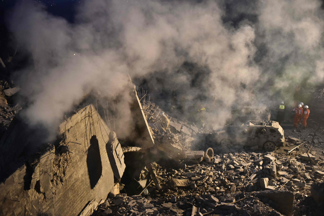 Rescue teams work at the scene of an Israeli airstrike that targeted a house where displaced people lived in the village of Baalshmay in the Lebanese mountains, east of Beirut, on Tuesday (AFP photo)