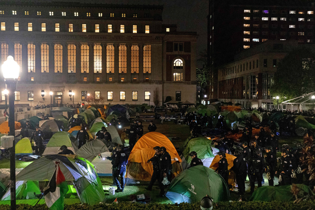 NYPD officers in riot gear enter Columbia University's encampment as they evict a building that had been barricaded by pro-Palestinian student protesters in New York City on Tuesday (AFP photo)