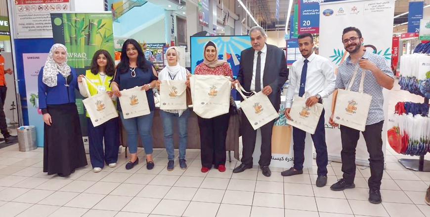 Participants pose for a photo during an event at a commercial centre to distribute eco-friendly cotton bags (Photo courtesy of the Ministry of Environment)