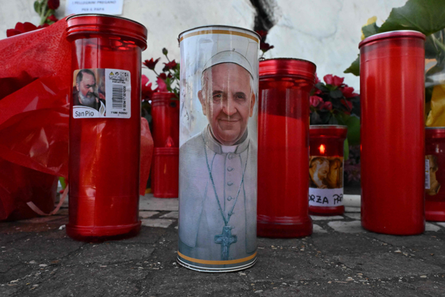  Candles are laid at the Gemelli University Hospital where Pope Francis is hospitalized with pneumonia, in Rome today (AFP photo)