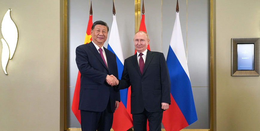 In this pool photo distributed by the Russian state agency Sputnik, Russia's President Vladimir Putin meets with China's President Xi Jinping on the sidelines of the Shanghai Cooperation Organisation member states leaders' summit in Astana on Wednesday (AFP photo)