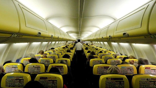 A cabin crew member serves passengers onboard a Ryanair passenger aircraft travelling from Madrid International Airport to Bergamo Airport, Italy, on Friday (Reuters file photo)
