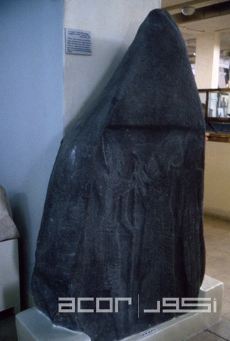 Late Bronze II 13th-12th century Stele with three figures below and worn inscription above, in the collection of the Jordan Archaeological Museum at the Amman Citadel (Photo courtesy of ACOR)