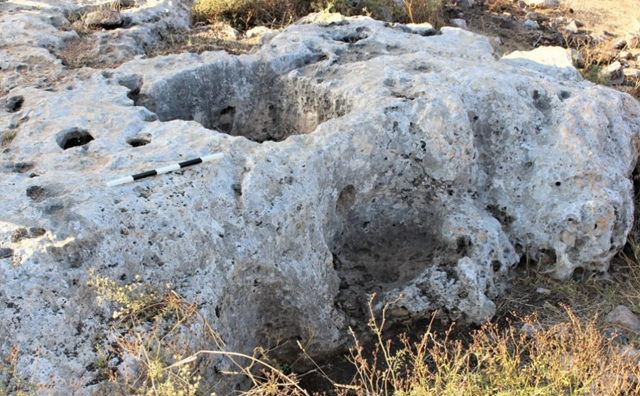 An olive press cut into limestone bedrock at Khirbet Um Al Ghozlan (Photo by Adam Carr)