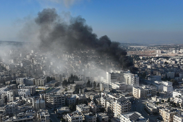 An aerial photo shows smoke rising from the site of an airstrike that targeted Syria's rebel-held northern city of Idlib on Monday (AFP photo)