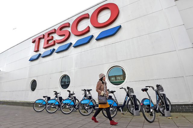 A woman walks past a Tesco supermarket in central London on December 9, 2014 (Reuters file photo)