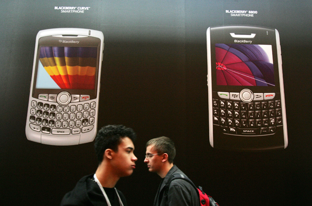 In this file photo taken on March 4, 2008, people walk past the BlackBerry stand at the CeBIT trade fair in Hanover (AFP photo)