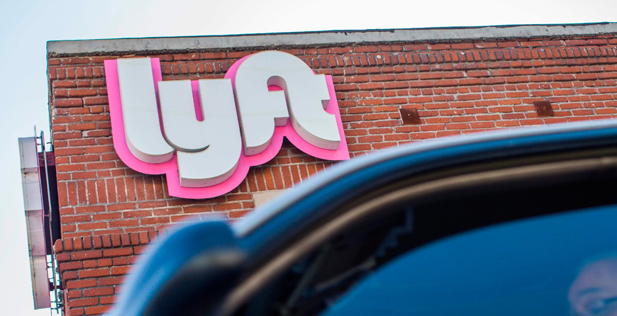 A driver rides his car in front of the Lyft Drivers Hub in Los Angeles, California, on Friday (AFP photo)