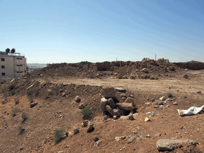 Tell Al Rumayth, a fortified settlement from Iron Age, is surrounded by apartment and commercial buildings (Photo courtesy of Mohammad Najjar)