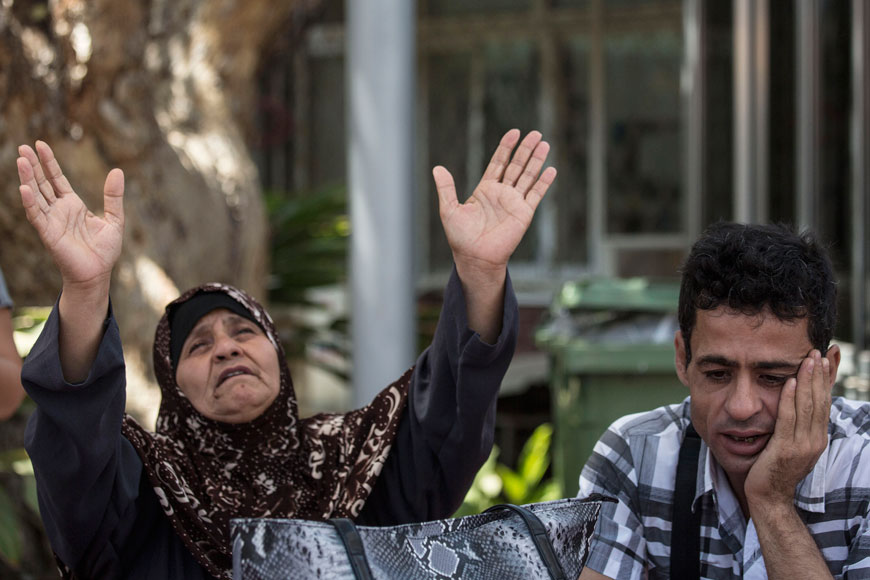 In this  August 19 file photo, Mazoza Allan (left) and Amid Allan, a brother of Mohammed Allan, a Palestinian prisoner on a hunger strike, wait outside Barzilai Hospital in Ashkelon, southern Israel (AFP photo)
