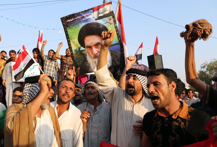 Protesters chant in support for the Shiite spiritual leader Grand Ayatollah Ali Al Sistani, in the poster, during a demonstration in Basra, 550 kilometres southeast of Baghdad, Iraq, on Friday (AP photo)