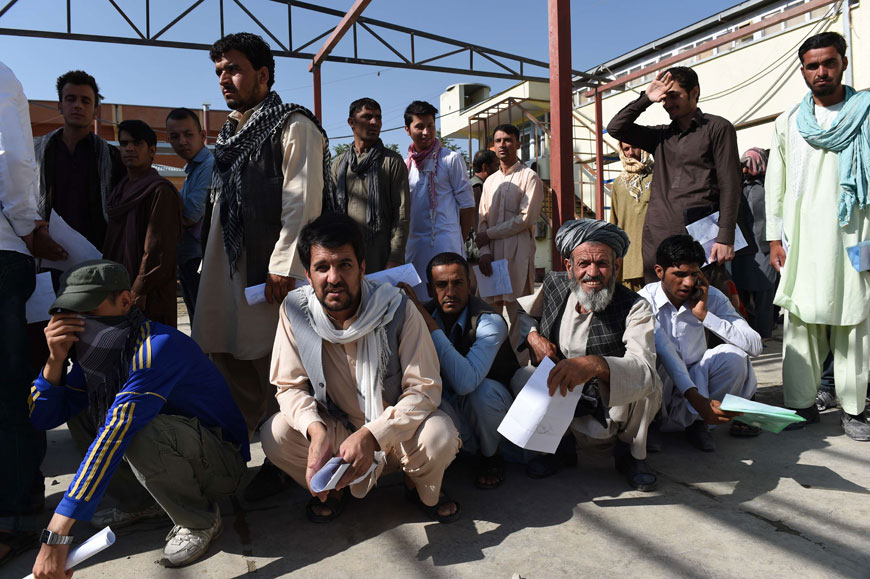 Afghan men wait as they apply for passports at the passport office in Kabul on Tuesday. The toppling of the repressive Taliban regime in 2001 had ignited new hope about the future of Afghanistan, bringing waves of Afghan refugees home, but recent years have witnessed a stark reversal of that trend. The snaking queues outside Kabul's passport office are a totemic indicator that the exodus is gathering fresh momentum as pessimism abounds about the deteriorating war, the tanking economy and a government widely derided as lacking direction (AFP photo)
