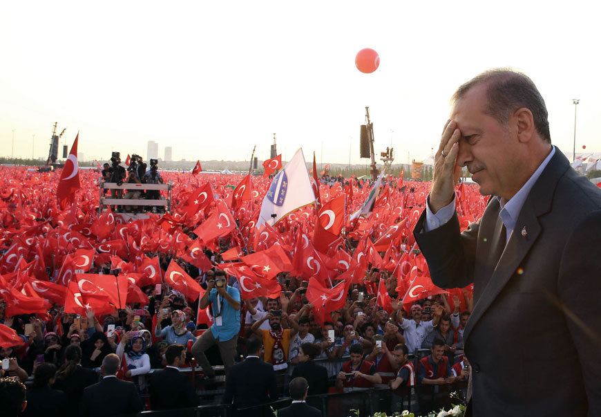 Turkey's President Recep Tayyip Erdogan salutes supporters as tens of thousands of flag-waving demonstrators rally to denounce violence by Kurdish rebels, in Istanbul, on Sunday (AP photo)