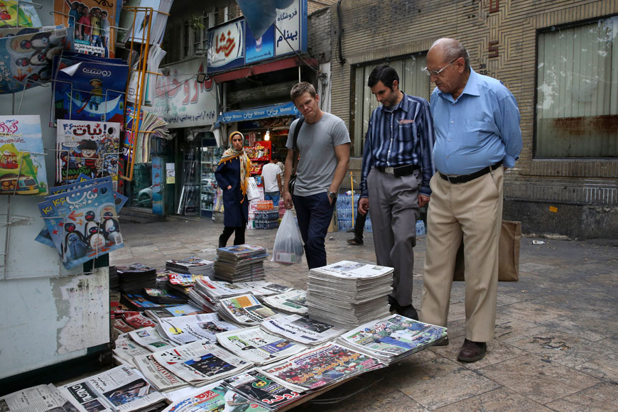 People read front pages of Iranian newspapers at a news stand in the Tajrish Square, northern Tehran, on Tuesday (AP photo)