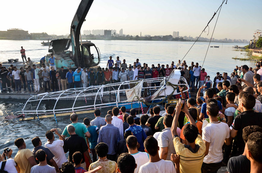 Egyptians look at the passenger boat that sunk in the River Nile in Giza, south of Cairo, Egypt, on Thursday (AP photo)