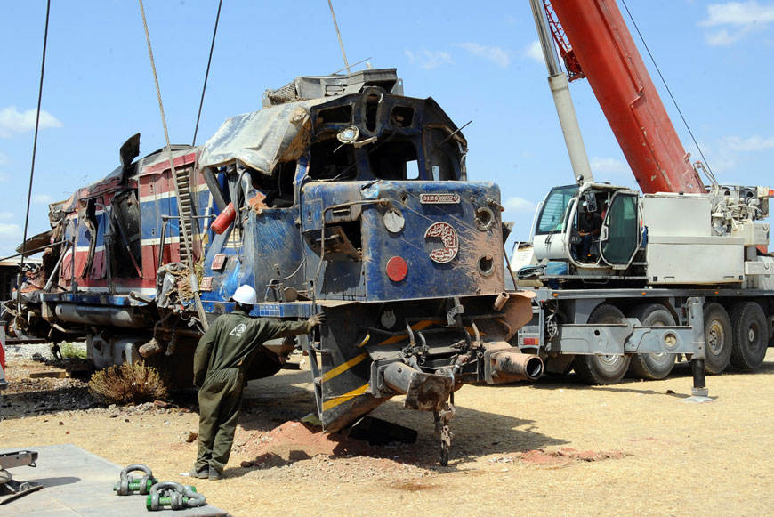 Workers help removing the wreckage of a train outside Fahs, 60 kilometres from Tunis, Tunisia, on Tuesday (AP photo)