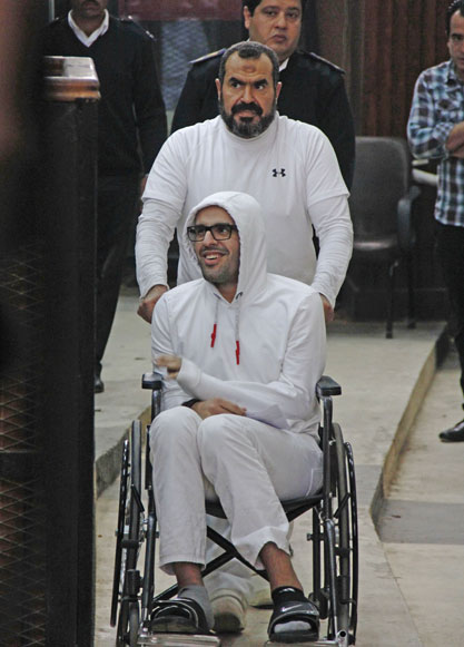 In this March 9 photo, Mohammed Soltan is pushed by his father Salah during a court appearance in Cairo, Egypt. Egyptian officials say authorities have freed Soltan, a dua US-Egyptian citizen on Saturday (AP photo)