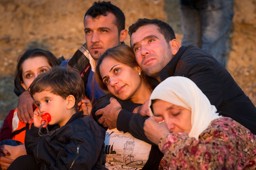 Migrant family members hug each other after successfully arriving on the coast by dinghy after crossing from Turkey, in the southeastern island of Kos, Greece, early Thursday (AP photo)