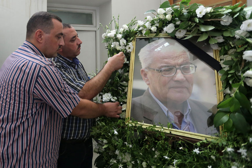 The sons of Khaled Al Assaad, the late 82-year-old retired chief archaeologist of the ancient Syrian city of Palmyra, Omar (left) and Mohammad display a portrait of their father during a ceremony in his memory at the National Museum on Sunday in the Syrian capital Damascus (AFP photo)
