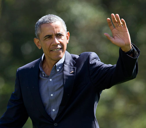 President Barack Obama waves as he walks on the South Lawn of the White House in Washington Monday upon his return from a Labour Day trip to Boston (AP photo)