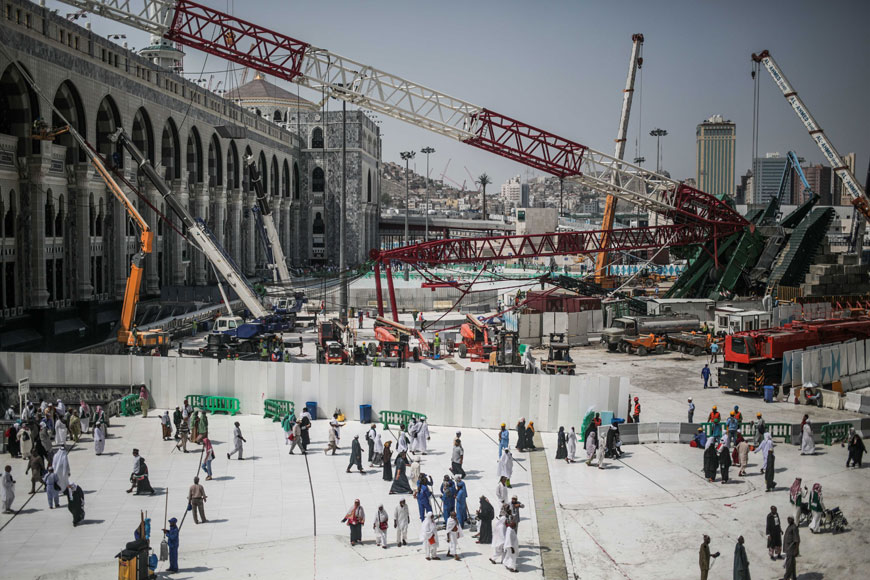 Muslim pilgrims walk past the site of a crane collapse that killed over a 100 on Friday at the Grand Mosque in the holy city of Mecca on Tuesday (AP photo)