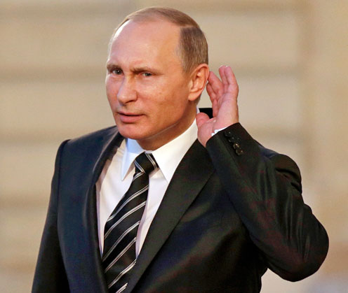 Russian President Vladimir Putin cups his ear to listen to a question as he departs after a summit on the Ukraine crisis at the Elysee Palace in Paris, France, on Friday (Reuters photo)