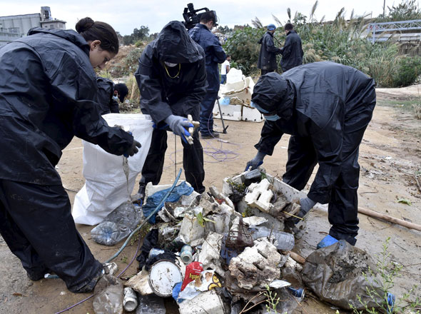 ‘You Stink’ activists collect trash during a campaign to remove piled garbage on the bank of Beirut river, Lebanon, on Sunday. Uncollected refuse were crumbled in the streets of Beirut on Sunday after heavy rain (Reuters photo)