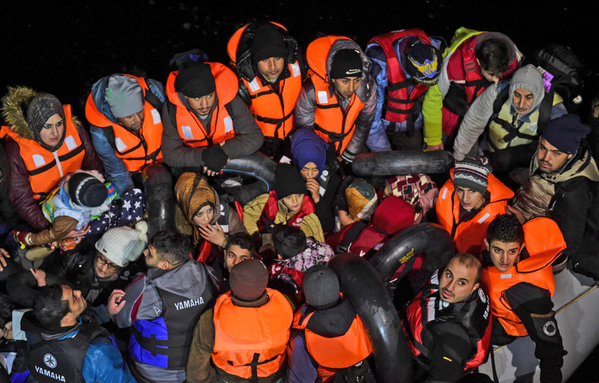 Syrian migrants wait aboard an inflatable dinghy after being rescued while attempting to reach the Greek Island Chios on the Agean Sea near Izmir in the night of Wednesday to Thursday (AFP photo)