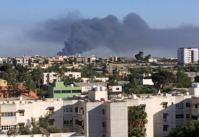 Smoke rises during a fight between members of the Libyan internationally recognised government forces and Eastern forces in Ain Zara, Tripoli, Libya, on Saturday (Reuters photo)