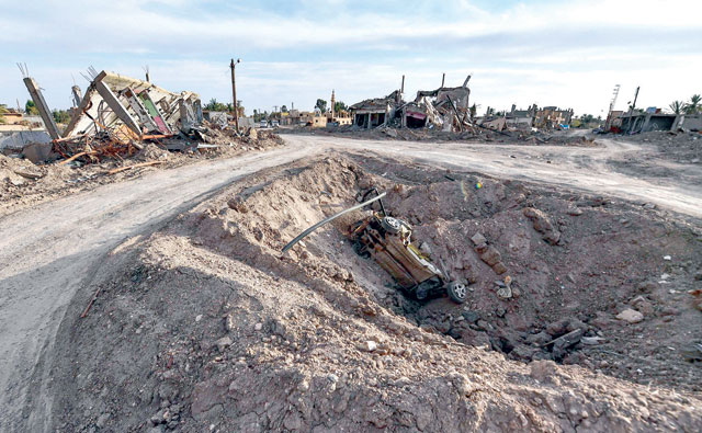This photo taken on Thursday shows a view of destroyed houses and vehicles in the village of Sousa, near the village of Baghouz in the eastern Syrian province of Deir Ezzor (AFP photo)
