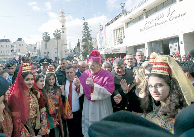Latin Patriarch of Jerusalem Pierbattista Pizzaballa is greeted by a crowd as he arrives in the West Bank city of Bethlehem on Monday (AFP photo)
