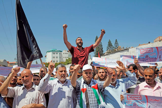   Palestinians in Gaza city shout slogans during a protest against a US-sponsored Middle East economic conference in Bahrain on Wednesday (AFP photo)